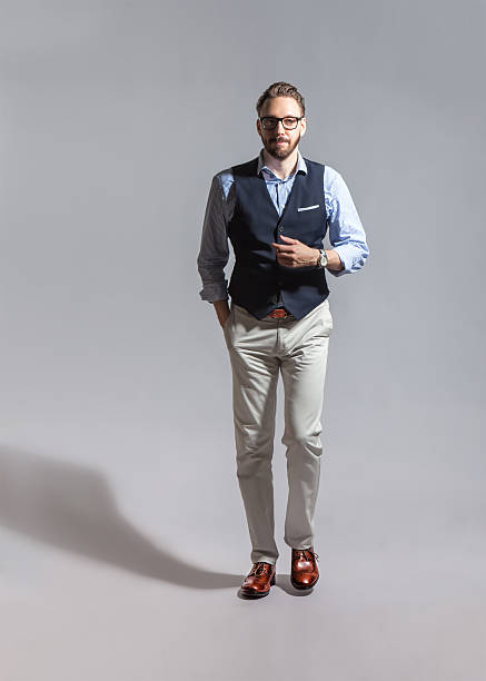 Walking suave stylish bearded man in classic vest stock photo