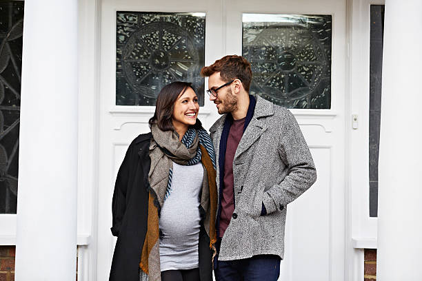 walks and fresh air are good for the baby - pregnant couple outside stockfoto's en -beelden