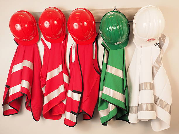 Wall hanger with vest and helmets  emergency warden team stock photo