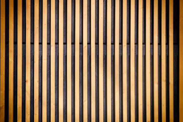 Wall of thin wooden slats. Vertical parallel plates. Background with vignette. stock photo