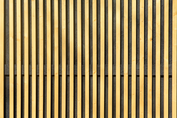 Wall of thin wooden slats. Vertical parallel plates. stock photo