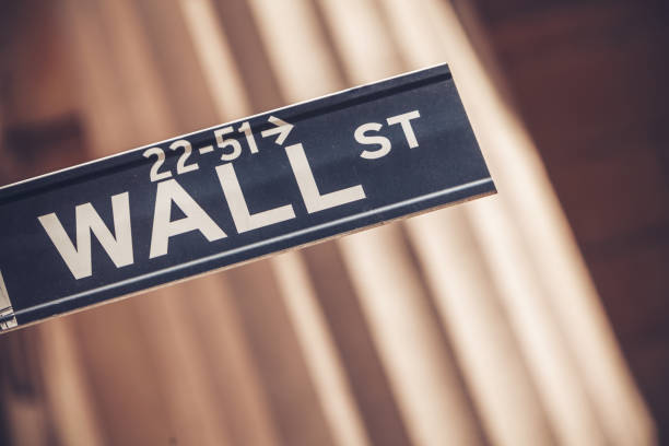 Wall street sign in New York with New York Stock Exchange background stock photo