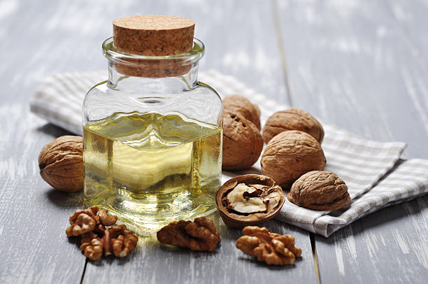 Walnut oil with nuts stock photo