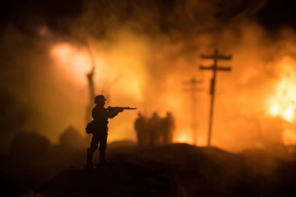 War Concept. Military silhouettes fighting scene on war fog sky background, World War Soldiers Silhouette Below Cloudy Skyline At night. Battle in ruined city. Selective focus stock photo