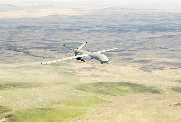 War drone flying over the desert stock photo