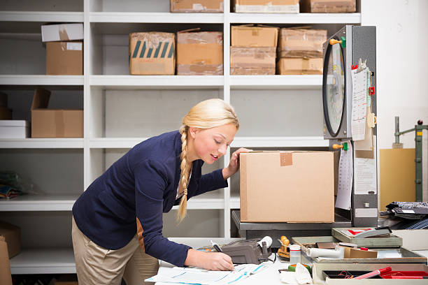 warehouse clerk checking a parcel stock photo
