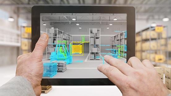 Hands holding a digital tablet showing artificial intelligence recognition on warehouse security computer screen. Machine learning person and object detection.