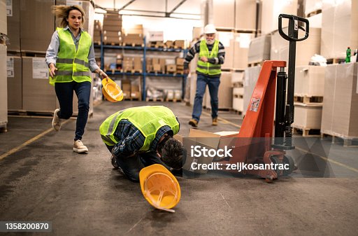 istock Warehouse worker after an accident in a warehouse 1358200870
