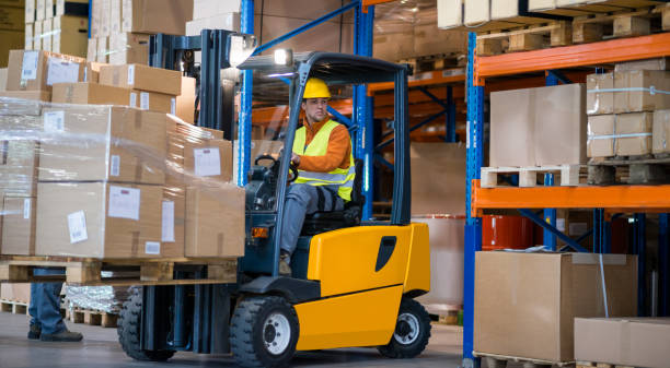 Warehouse Worker With Forklift stock photo