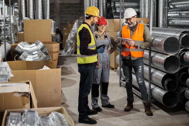 Warehouse workers checking packages in distribution center storage. stock photo