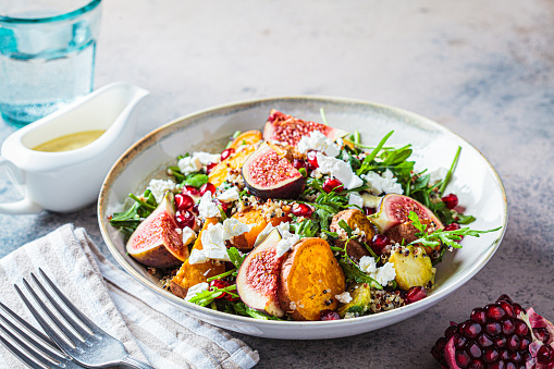 Warm autumn quinoa salad with baked vegetables (sweet potato, Brussels sprouts), figs, feta cheese and pomegranate.