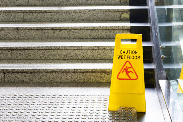 Warning sign for wet floor near the stair Warning sign for wet floor near the stair slip and fall stock pictures, royalty-free photos & images
