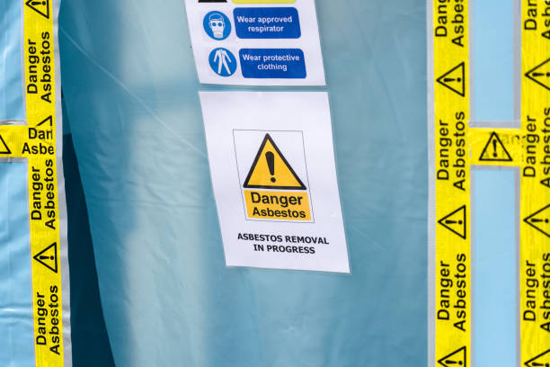 Warnings surrounding building entrance during asbestos removal stock photo