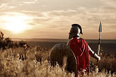istock Warrior wearing iron helmet and red cloak. 838078352