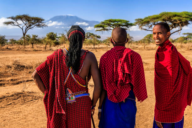 Warriors from Maasai tribe looking at Mount Kilimanjaro, Kenya, Africa African warriors from Maasai tribe, Mount Kilimanjaro on the background, central Kenya, Africa. Maasai tribe inhabiting southern Kenya and northern Tanzania, and they are related to the Samburu. masai warrior stock pictures, royalty-free photos & images