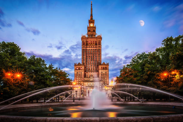 Warsaw and View of Palace of Culture and sciences (one of the main travel attractions - The Main symbol of Warsaw) with Fountain Close Up stock photo