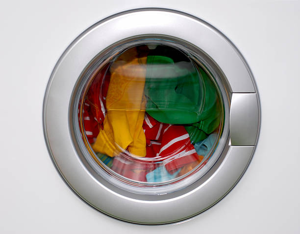 washing machine washing machine - filled with colorful laundry laundromat photos stock pictures, royalty-free photos & images