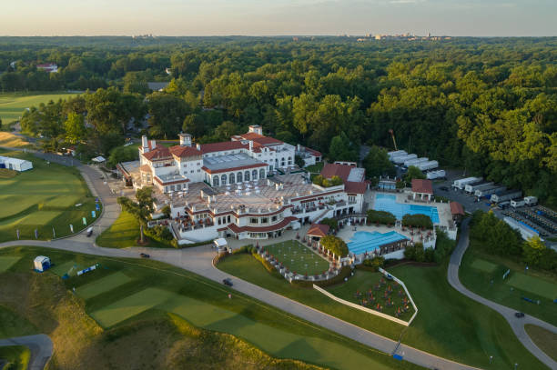 Washington DC Bethesda, MD, USA - June 21, 2022: An aerial image of the Congressional Country Club during the Ladies Professional Golf Association Tournament, showing the clubhouse and immediate surroundings at golden hour, with a few members visible but indistinguishable using the grounds and the facilities. Some accessories are in place on the grounds for the LPGA tournament. The image was captured by Nathanael Showalter of Hover Solutions, LLC operating a DJI Inspire 2 under the terms of a TSA waiver for the airspace. congressional country club stock pictures, royalty-free photos & images