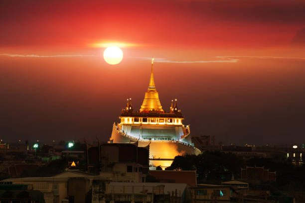 Wat Sraket Rajavaravihara Golden Mount , sun moving behind the temple. stock photo