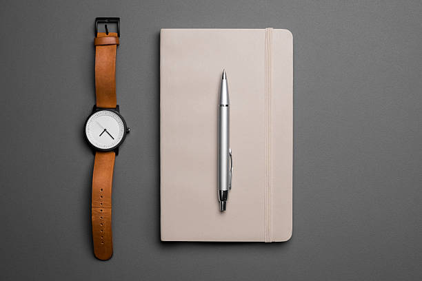Watch and notebook with pen stock photo