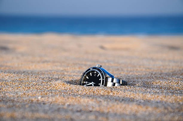 Watch in sand stock photo