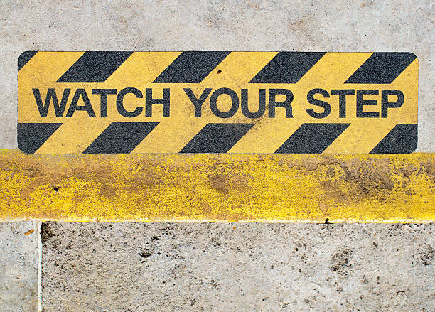 Watch your step warning sign text stock photo