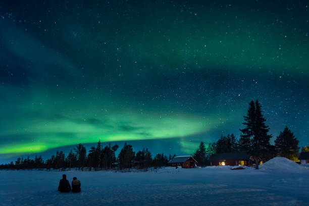Watching a night sky with aurora borealis stock photo