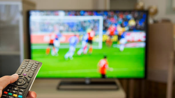 Watching football at home on TV Watching football at home on TV spectator stock pictures, royalty-free photos & images