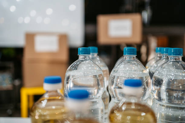 Water and oil bottles in volunteers center stock photo