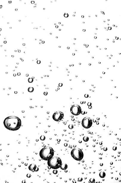 Water bubbles of different sizes against a white background stock photo