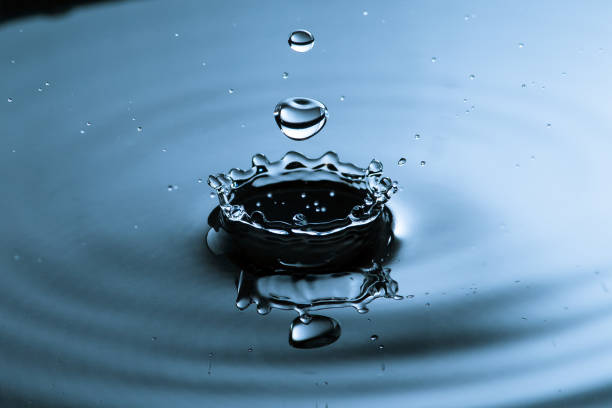 Water drop splashing stock photo