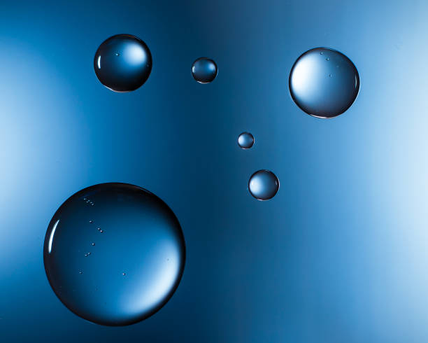 Water droplets on glass blue stock photo