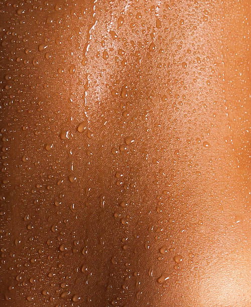 Water drops on the skin of a young woman. stock photo