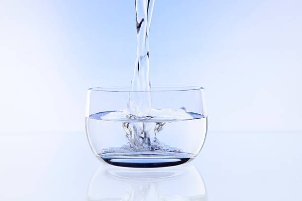 Water flowing into a bowl stock photo