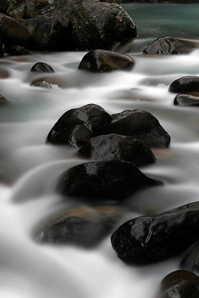 Water flowing through rocks stock photo