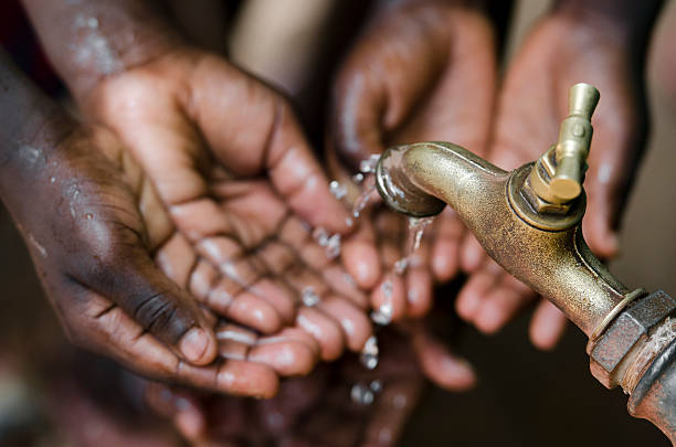 Water for Life Symbol Water scarcity is still affecting one sixth of Earth's population. African Children in developing countries suffer most from this problem, that causes malnutrition and health problems. developing countries stock pictures, royalty-free photos & images