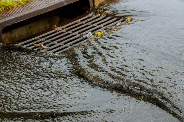 Water gushing from storm sewer following very heavy rainfall Water gushing from storm sewer following very heavy rainfall of the road after heavy rain. storm stock pictures, royalty-free photos & images