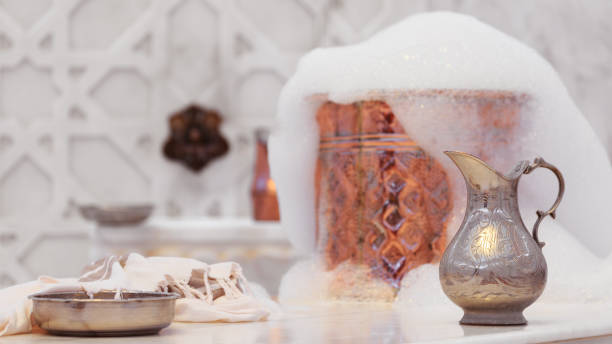 Water jar, towel and copper bowl with soap foam in turkish hamam. Traditional interior details Water jar, towel and copper bowl with soap foam in turkish hamam. Traditional interior details. Horizontal, wide screen format turkish bath photos stock pictures, royalty-free photos & images
