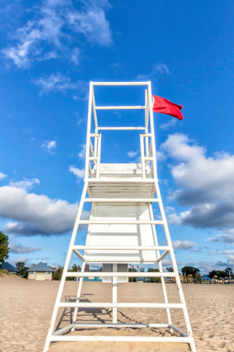 Water lifeguard stand with red flag
