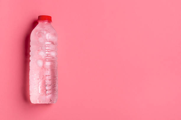 Water plastic bottle on pink background. Cold bottle of water Frosty plastic bottle with clean fresh water. Cold water in a plastic bottle on a pink background flat lay frozen water stock pictures, royalty-free photos & images
