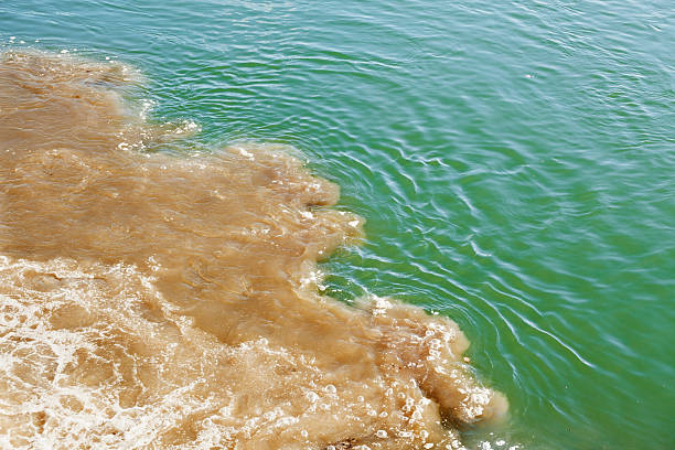 Water pollution Pollution;  toxic water is being pumped directly in the river;  water pollution stock pictures, royalty-free photos & images