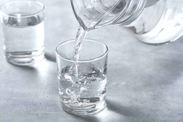 Water pouring into glass stock photo