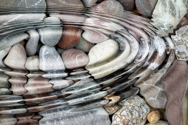 Water ripples over the stone pebbles stock photo