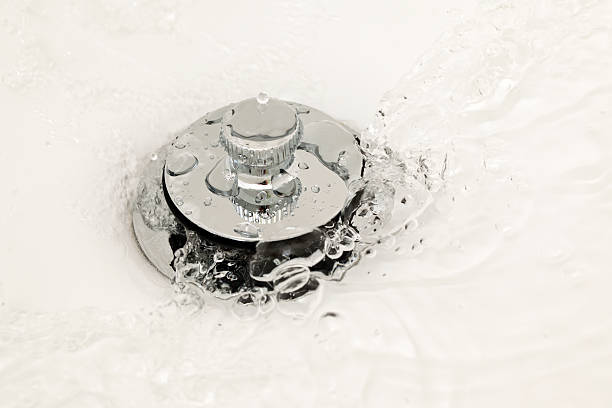 Water Running Down the Drain Water running down the drain. bath tub plug stock pictures, royalty-free photos & images