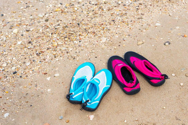 Water shoes on the beach stock photo