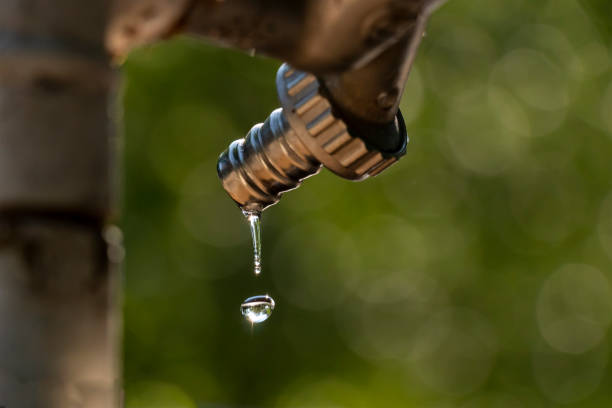 Water shortage, faucet dripping, water drop stock photo