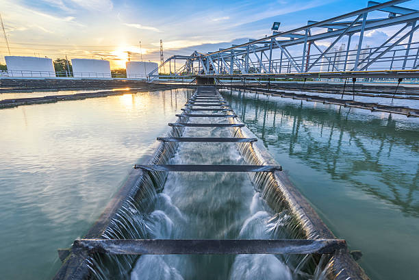 water treatment plant at sunset - i̇nşa edilmiş yapılar stok fotoğraflar ve resimler