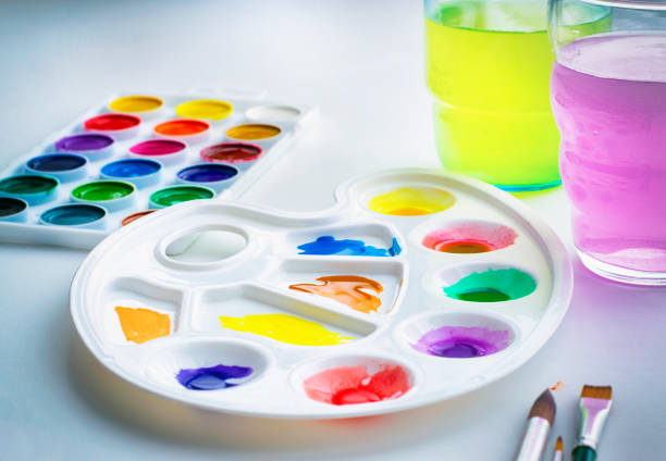 Watercolour paints and a palette on a white background. stock photo