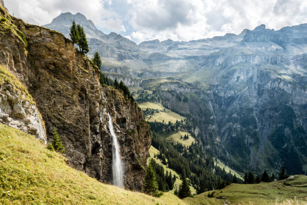 Waterfall above Spiggengrund, from Kiental to Lauterbrunnen, Switzerland Waterfall in the mountains, from Kiental to Lauterbrunnen, Switzerland rock face stock pictures, royalty-free photos & images
