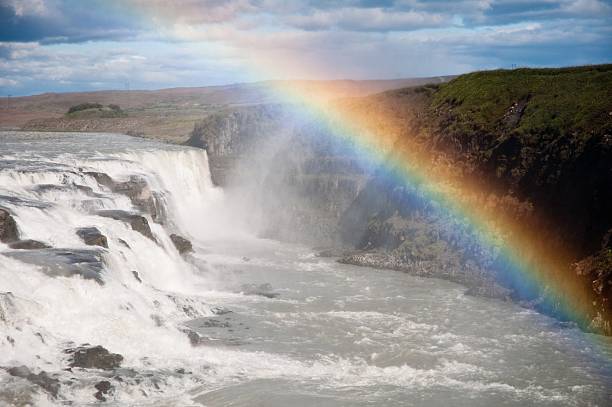 waterfall with beautiful genuine rainbow stock photo